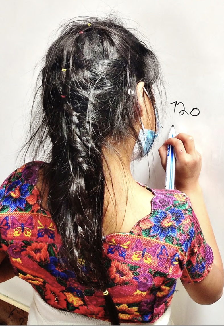 Juntos Podemos Girl Writes on Whiteboard (1)